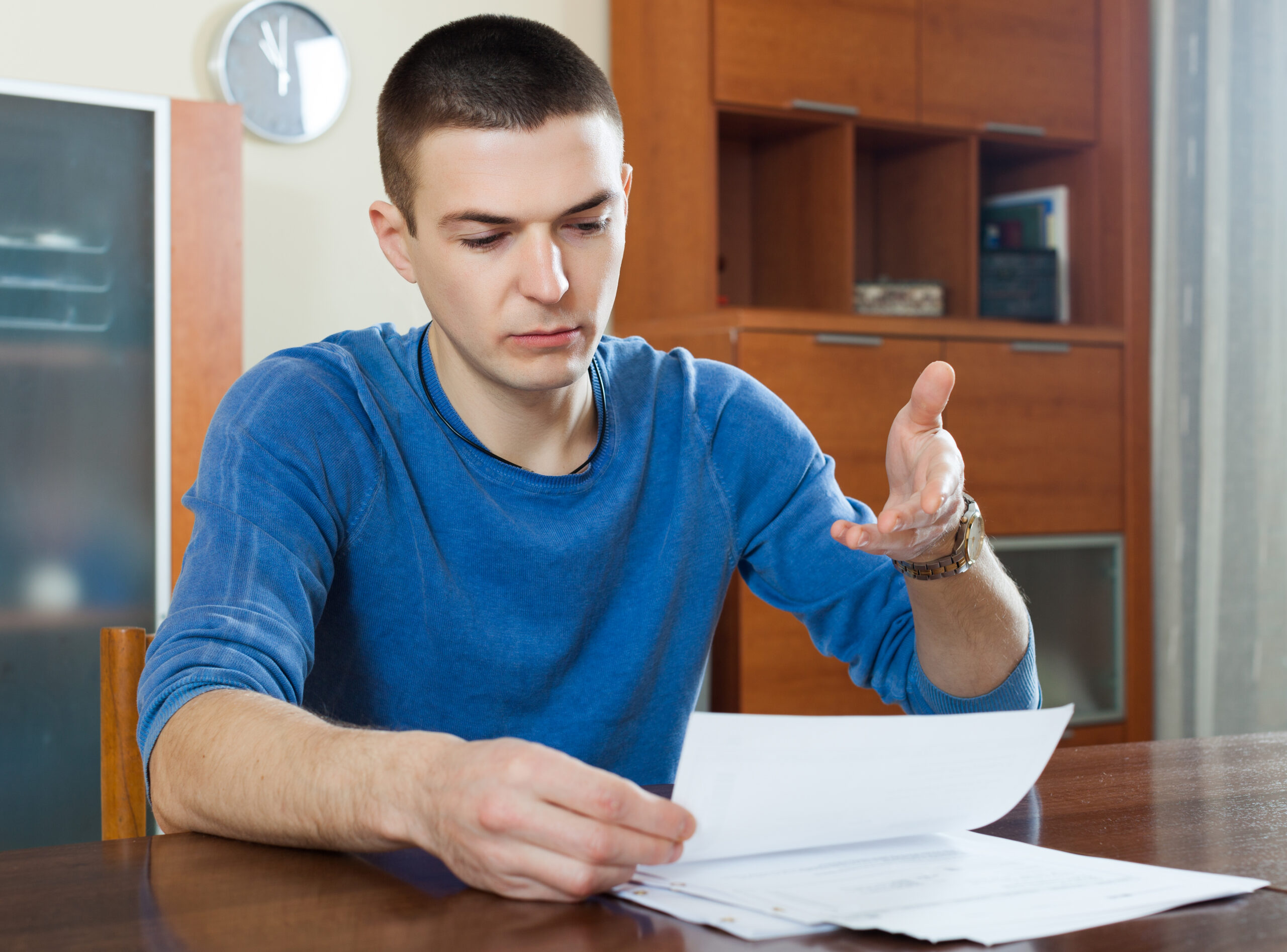 guy fills in financial documents